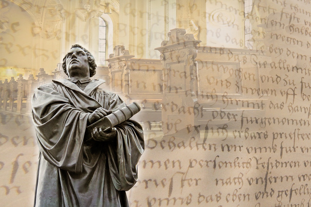 Statue of Martin Luther overlayed on background of church and german words