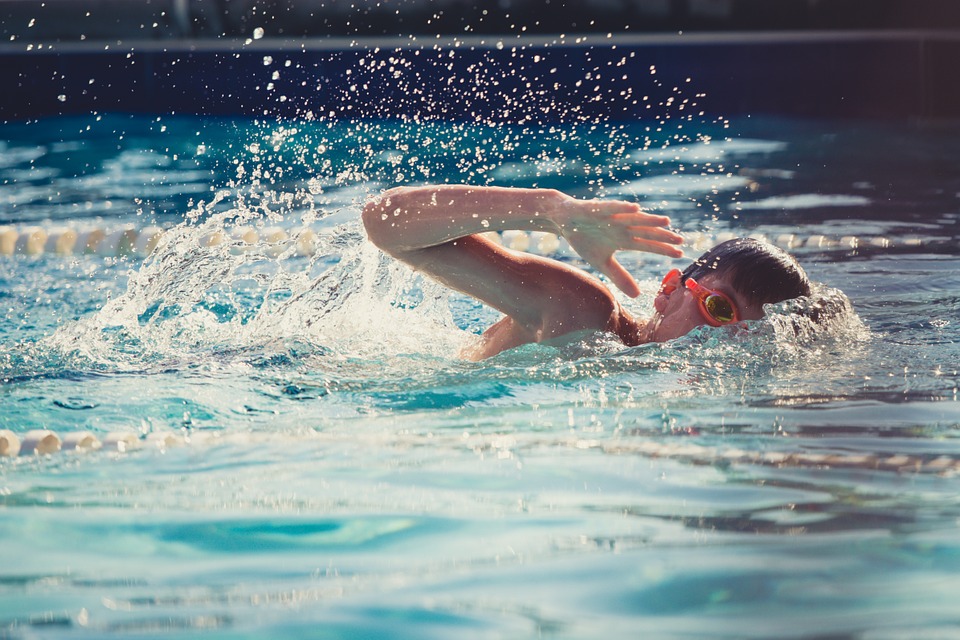 boy swimming lap in a pool
